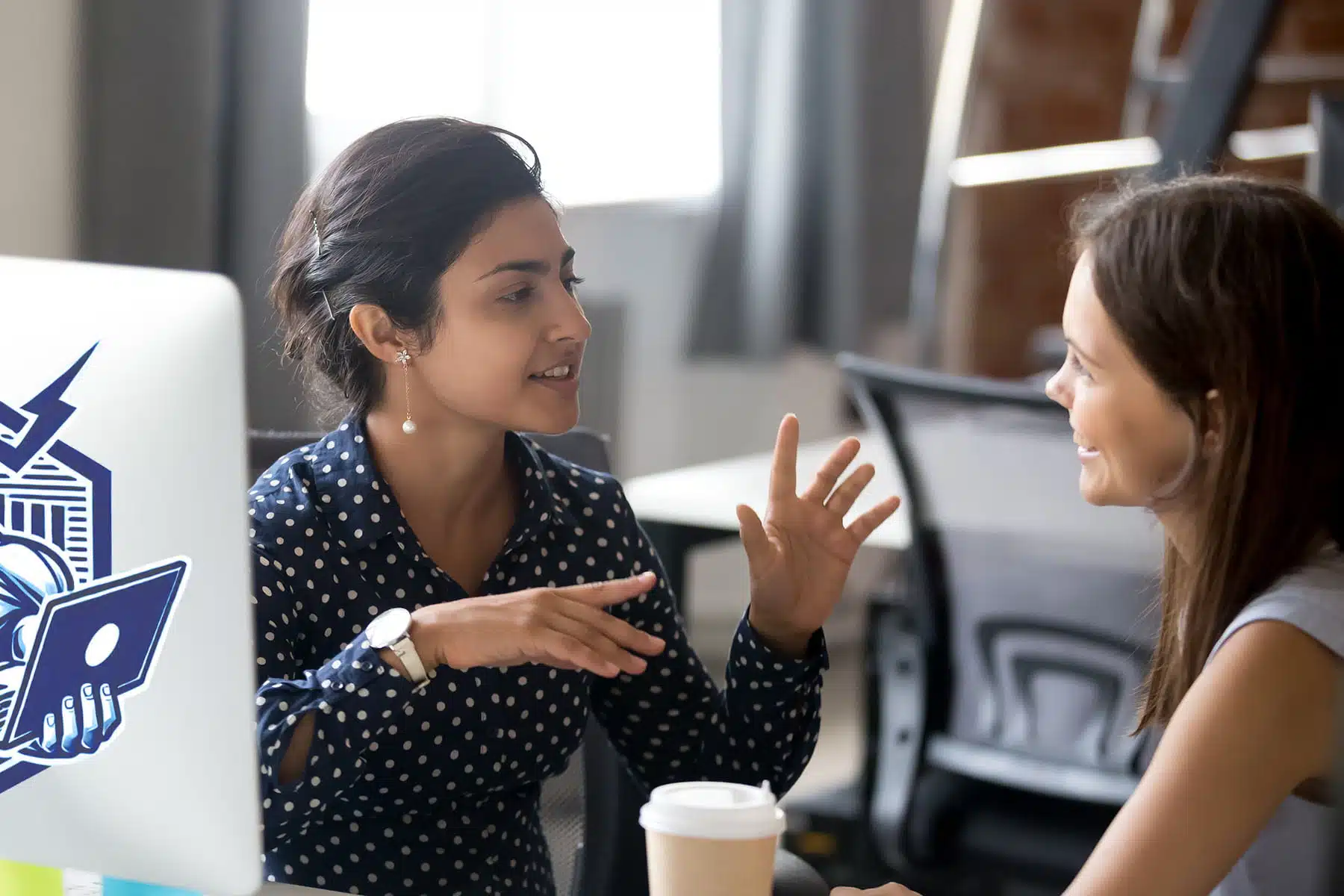 Female colleagues having a conversation about hosting at work