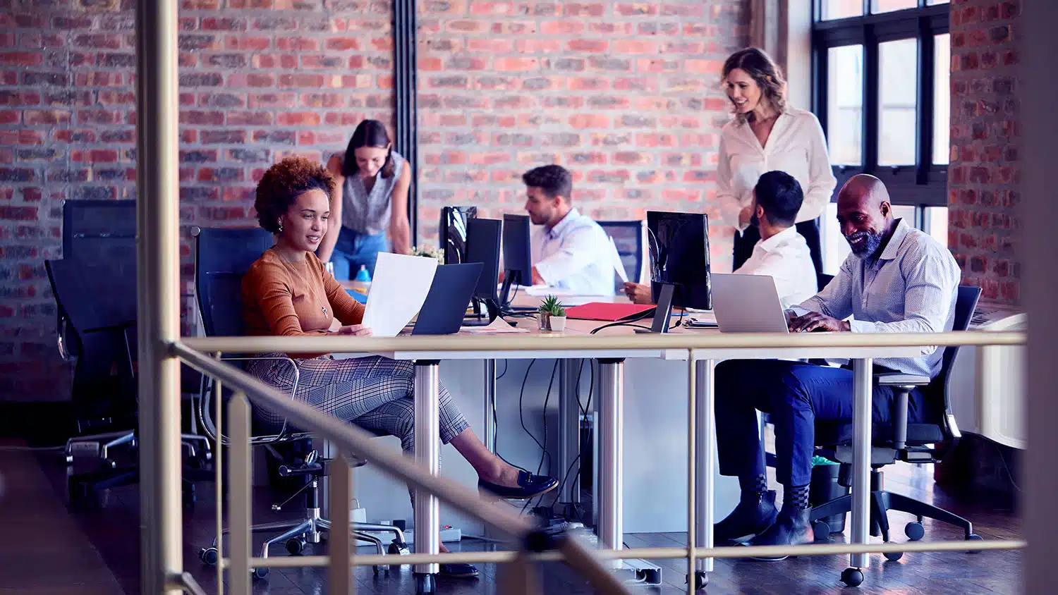 Business Team Working Together In Busy Multi-Cultural Office